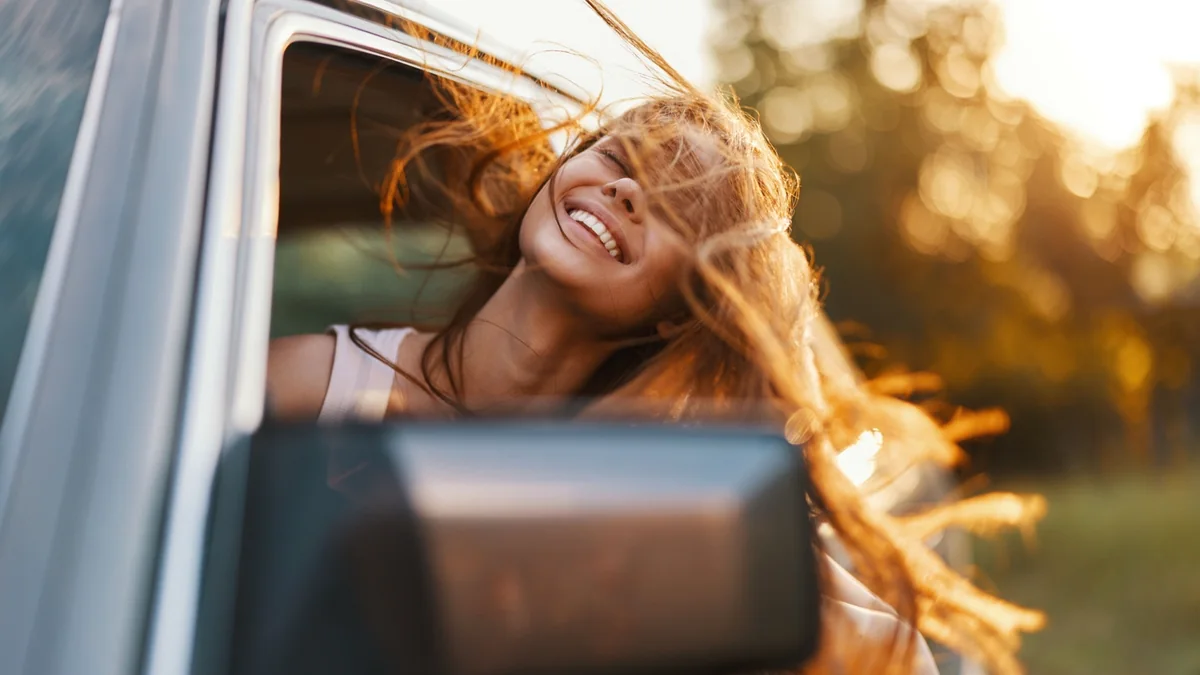 Junge Frau während eines USA-Roadtrips im Mietwagen